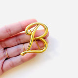 BROCHE B DORADO